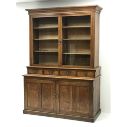  Edwardian oak glazed bookcase on cupboard fitted with drawers and collectors slides enclosed by two panelled doors, W142cm, H194cm, D57cm  