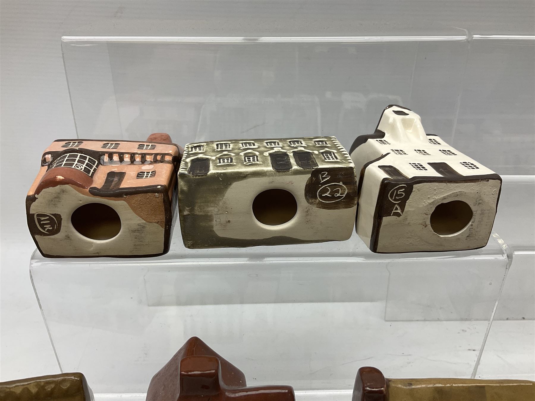 Twenty studio pottery figures of houses and cottages, comprising seventeen Mudlen End Studio Felsham Suffolk examples and two John Putman's Heritage Houses examples