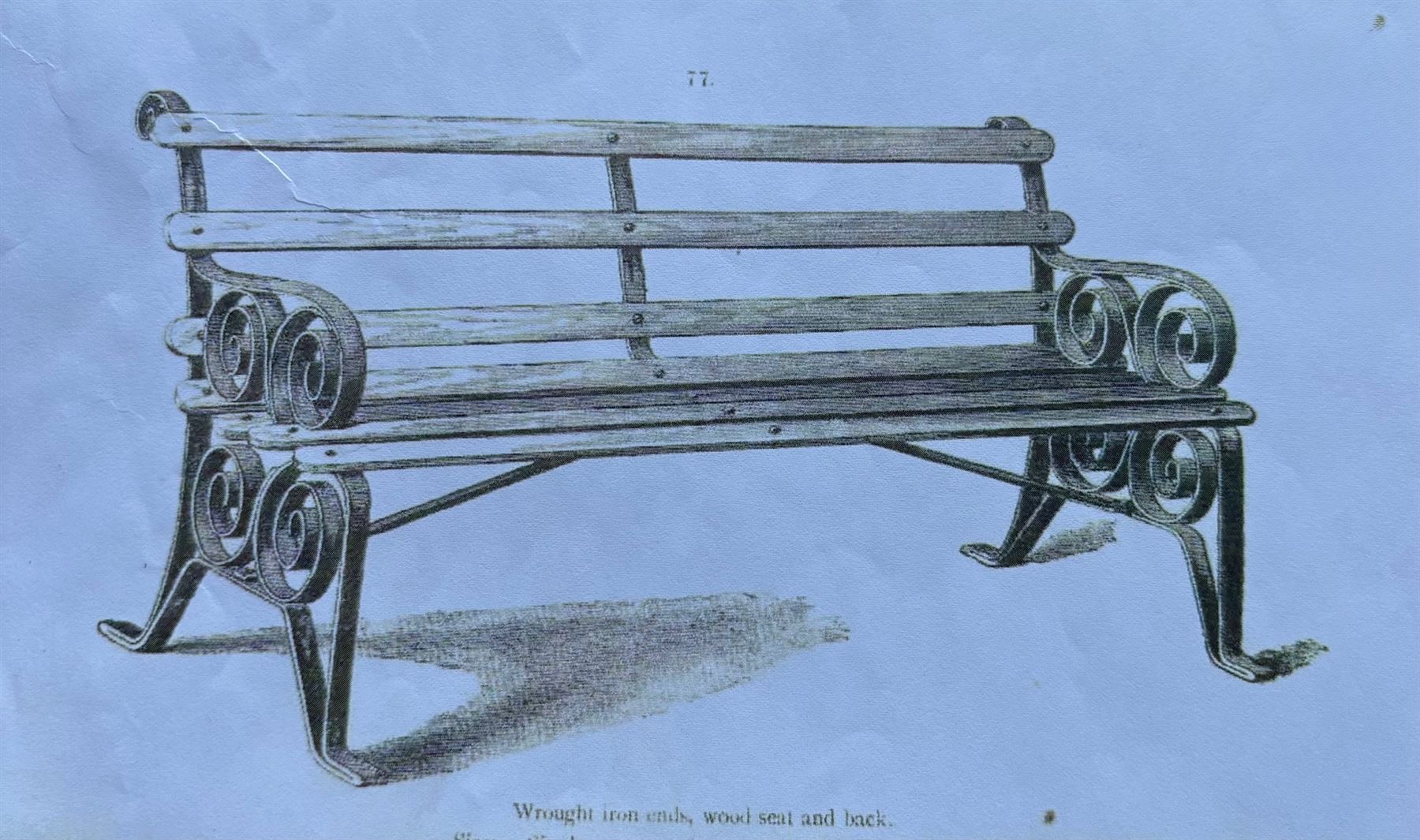 Coalbrookdale - rare pair of wrought iron and slatted wood garden benches, the twin wrought iron strapwork bench-ends formed of four scrolls over splayed feet, number 77 in the Coalbrookdale Castings Catalogue (see illustration)