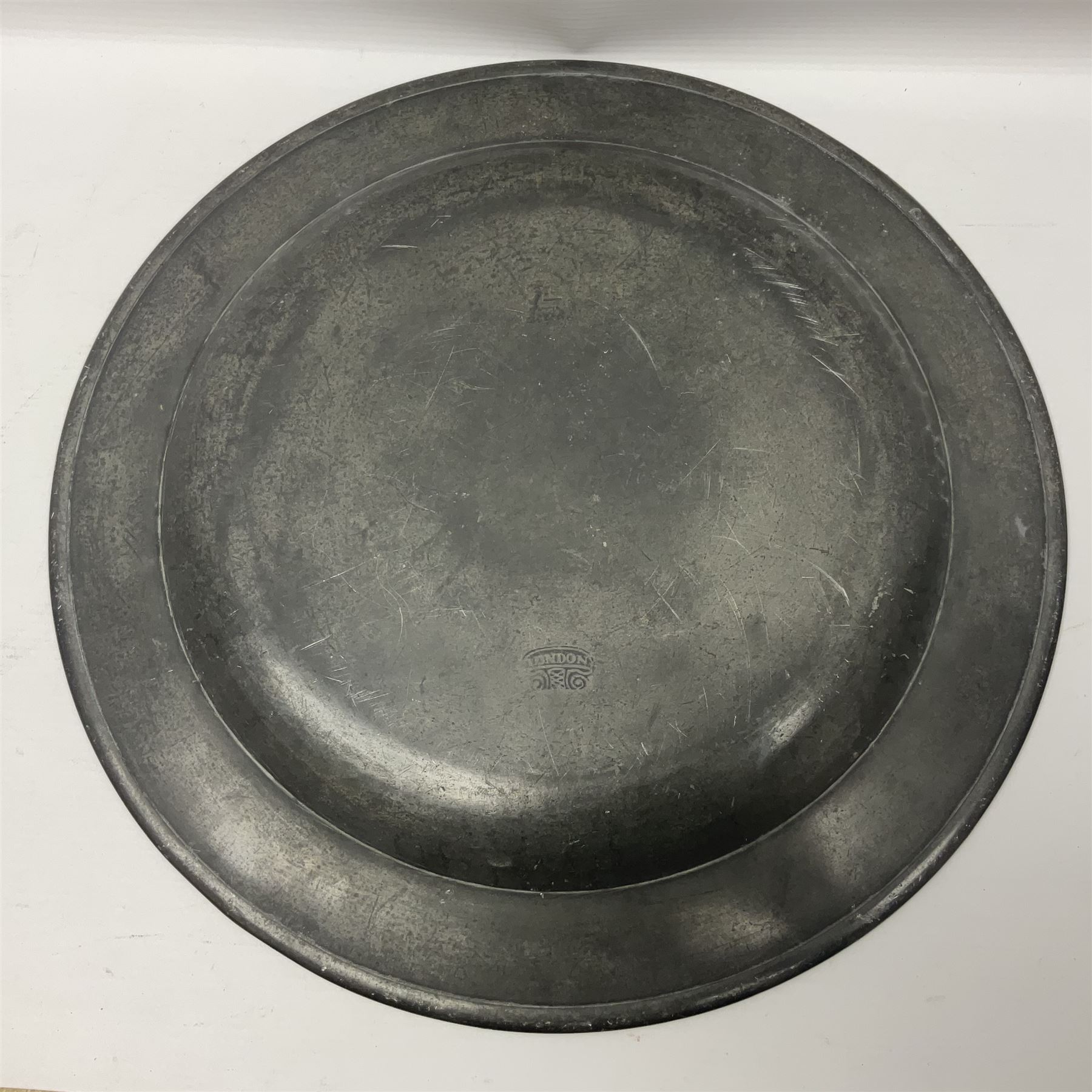 Group of seven 19th century pewter chargers, each of circular form with dished centre, two examples with touch marks verso, each approximately D39cm