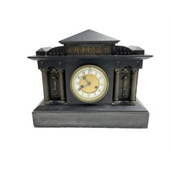 Slate mantle clock c1890 with an American “Waterbury” eight-day spring driven movement striking the hours on a gong (missing) Architectural styled case with recessed reeded brass columns to the front and depiction from Greek mythology to the tympanum, two-part dial with Arabic numerals to the chapter ring and a decorative gilt centre. With Pendulum.