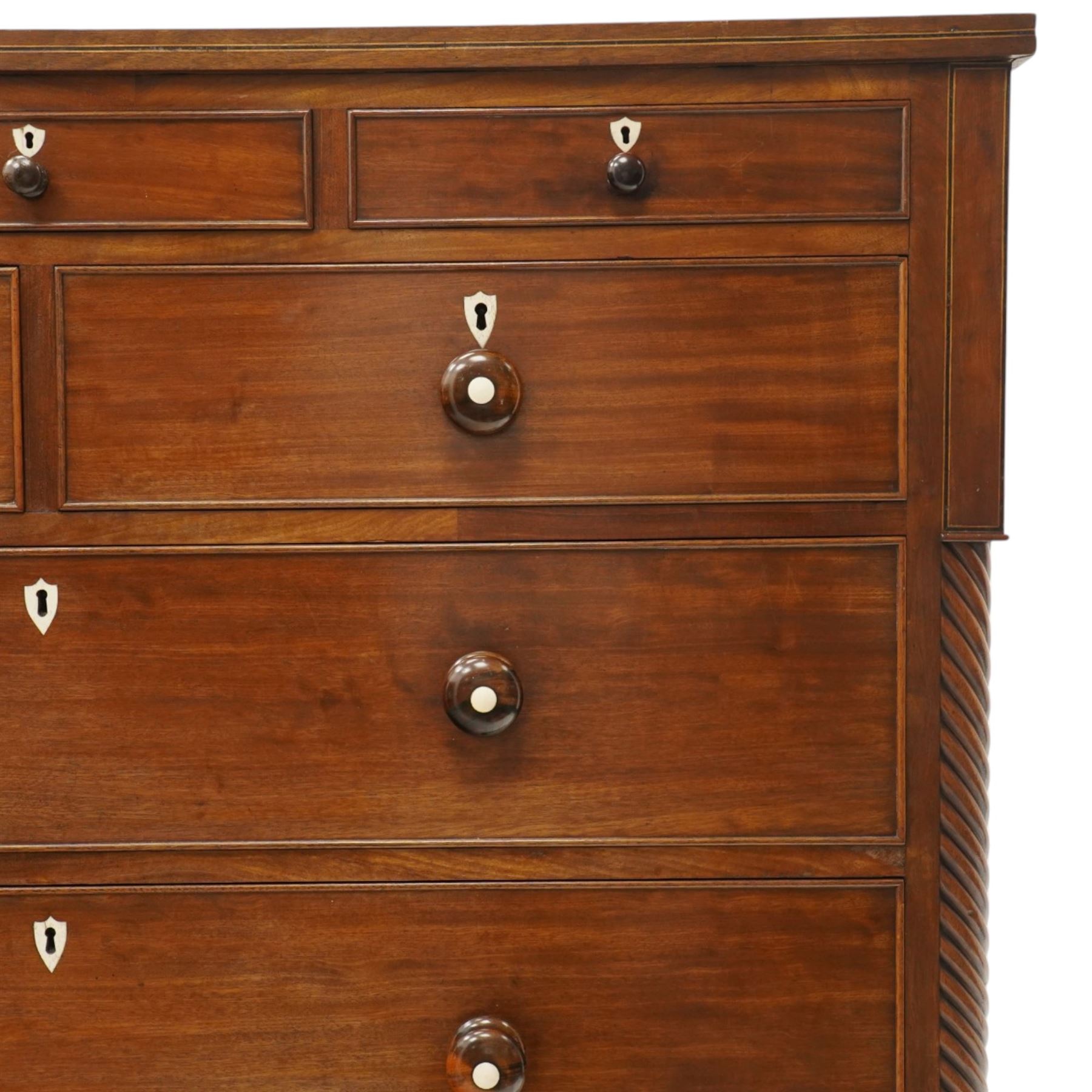 Large 19th century mahogany chest, with rectangular top with inlay flanked by spiral turned uprights, three short drawers above two short and three graduating long drawers, bone escutcheons and turned wooden handles, shaped apron raised on bracket feet 