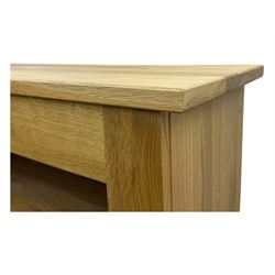 Contemporary light oak open bookcase, rectangular form with projecting top, fitted with five adjustable shelves, on a straight plinth base