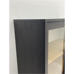 Laura Ashley - black finish cabinet enclosed by two glazed sliding doors, the interior fitted with three drawers (one fixed, two adjustable)