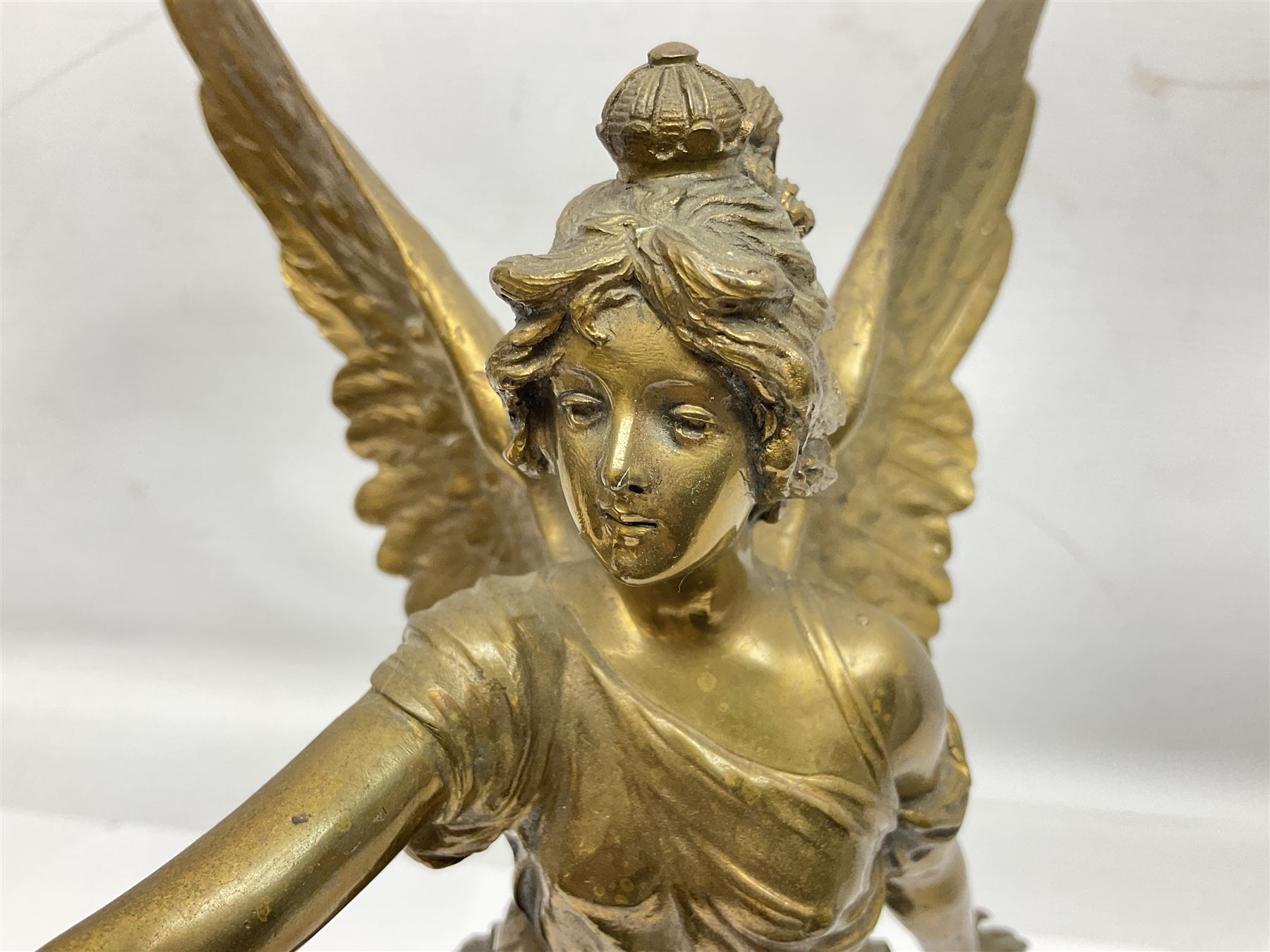 After Oswald Schimmelpfennig (German, 1872-1939): Pair of gilt bronze winged Allegorical female figures, the first example with arm outstretched holding a branch, signed 'Schimmelpfennig 1900', the second with arm raised above her head holding a book and sword in the other, both raised upon marble plinths, H45cm
