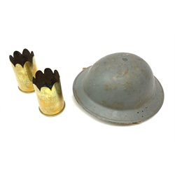 WW2 grey painted British Home Front steel helmet with original size 7 liner dated 1940 and marked BMB (Briggs Motor Bodies) and webbing chin strap, rim pierced with two sets of three holes indicating unsuitable for front line use D30cm; and pair of WW1 trench art brass shell case vases with undulating rims, one inscribed 'Souvenir of Le Bassee', the other 'Souvenir of Mons', dated 1918, H13cm (3)