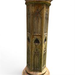 Farran stone garden statue depicting a hooded monk standing in flowing robes in circular form, set upon Gothic pedestal with arched panels, featuring lead hands and script band