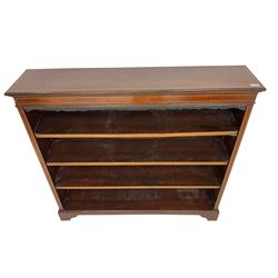 Edwardian inlaid mahogany open bookcase, rectangular top and frieze decorated with satinwood and ebony stringing, fitted with three adjustable shelves, on bracket feet