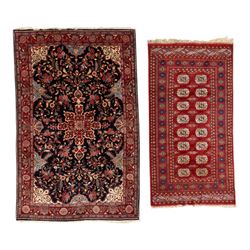 Two hand-knotted rugs, comprising Persian floral rug, dark blue ground decorated with scro...