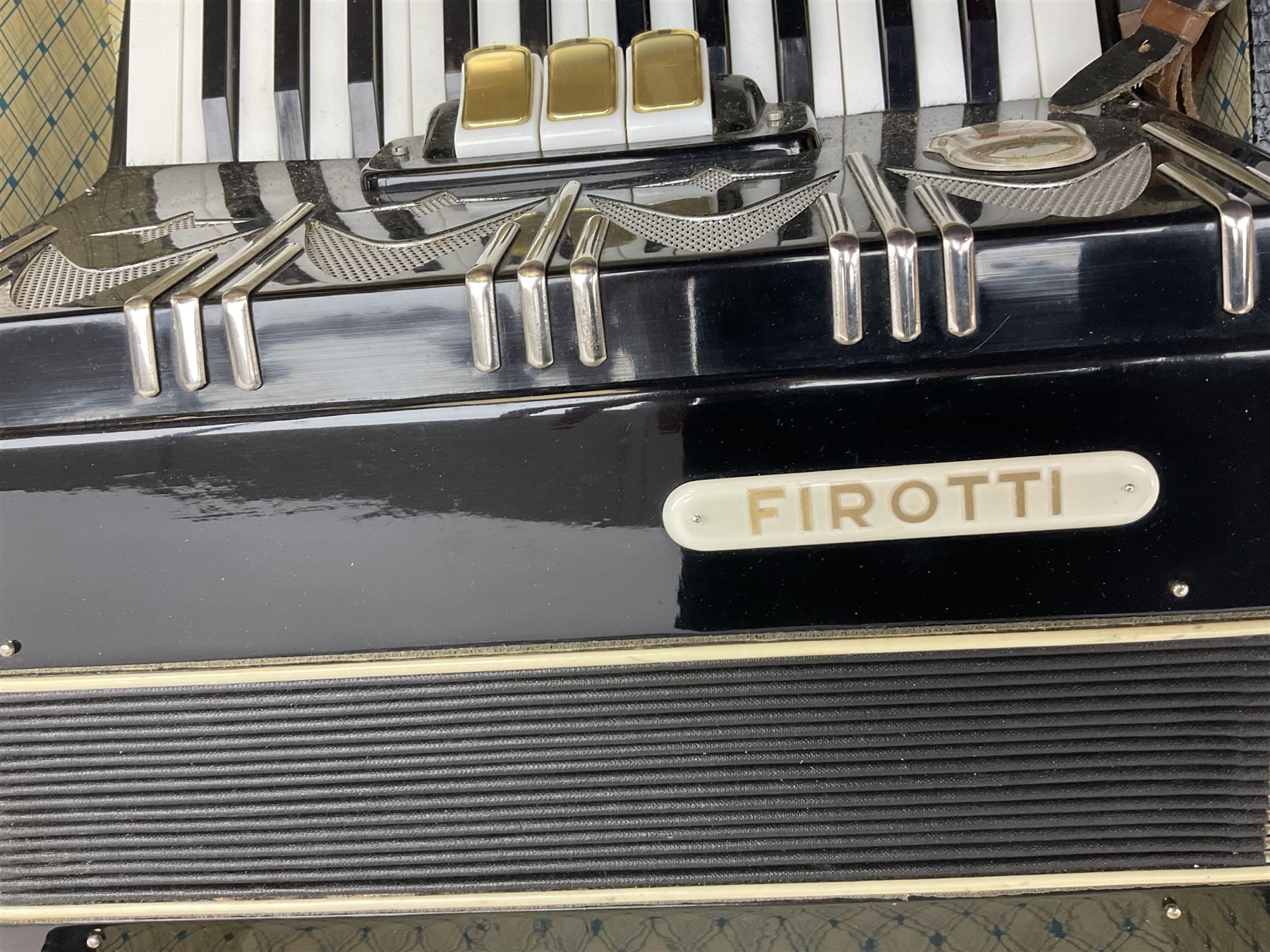 GDR Firotti piano accordion with black and silver case, sixteen keys and forty-eight buttons L38cm; in simulated reptile skin case with sheet music