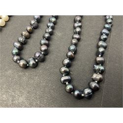 Four fresh water pearl necklaces, including a long two tone example, and a fresh water pearl three row bracelet