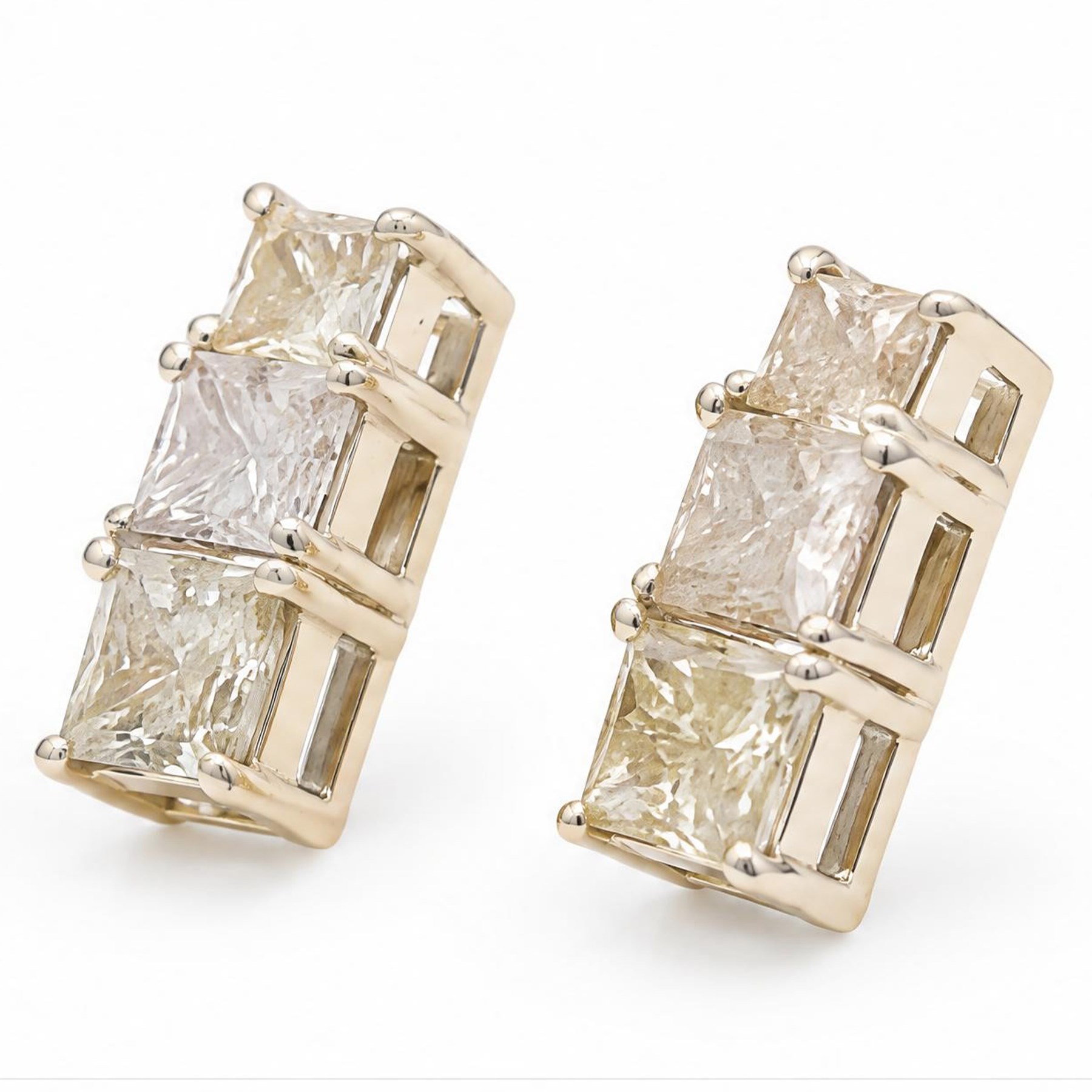 Pair of 18ct white gold diamond earrings, each stud set with three graduating princess cut diamonds, stamped 750, total diamond weight approx 1.70 carat
