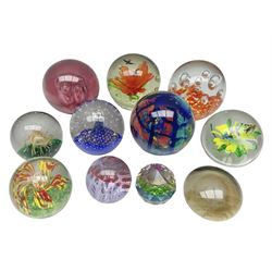 Collection of glass paperweights, to includes examples with internal air bubble inclusions and ones with internal flowers (11)