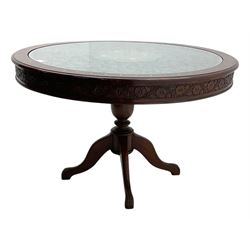 Pakistan carved hardwood brass inlaid circular dining table, and four rail back chairs with saddle seats