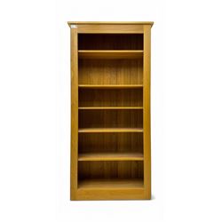 Contemporary light oak open bookcase, rectangular form with projecting top, fitted with fi...