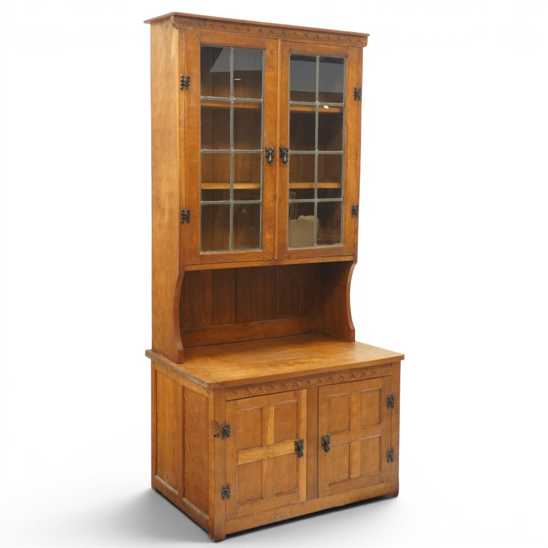Gnomeman - adzed oak dresser, arcade carved cresting rail over two lead glazed doors, double cupboard below enclosed by two panelled doors, with carved gnome signature, by Thomas Whittaker of Littlebeck 