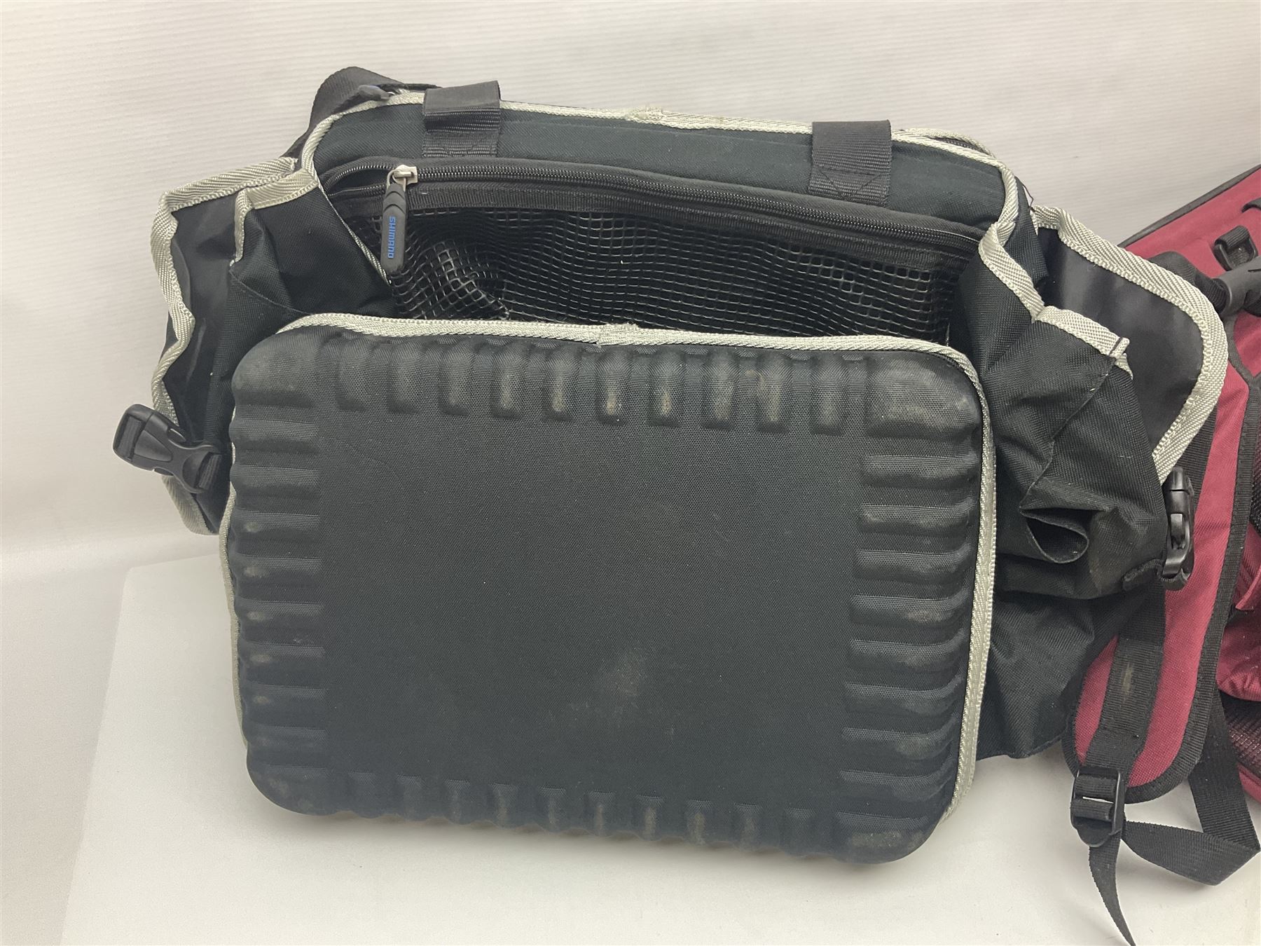 Collection of fishing memorabillia and equipment, including an Allcocks three piece split cane trout fly rod, Shakespeare Salt 3600 surf rod, two tackle bags, Old Red Seastreak multiplier reel, Sportext Saltwater fixed spool reel, fishing dvds, etc