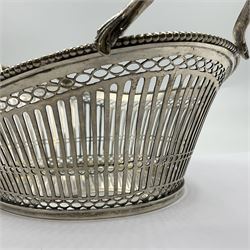 Early 20th century Dutch silver basket, of oval form with pierced sides, beaded rim, and twin handles, marked with Lion Passant for 2nd standard purity and date letter for 1910, other marks worn and indistinct, including handles H8.5cm L25.5cm