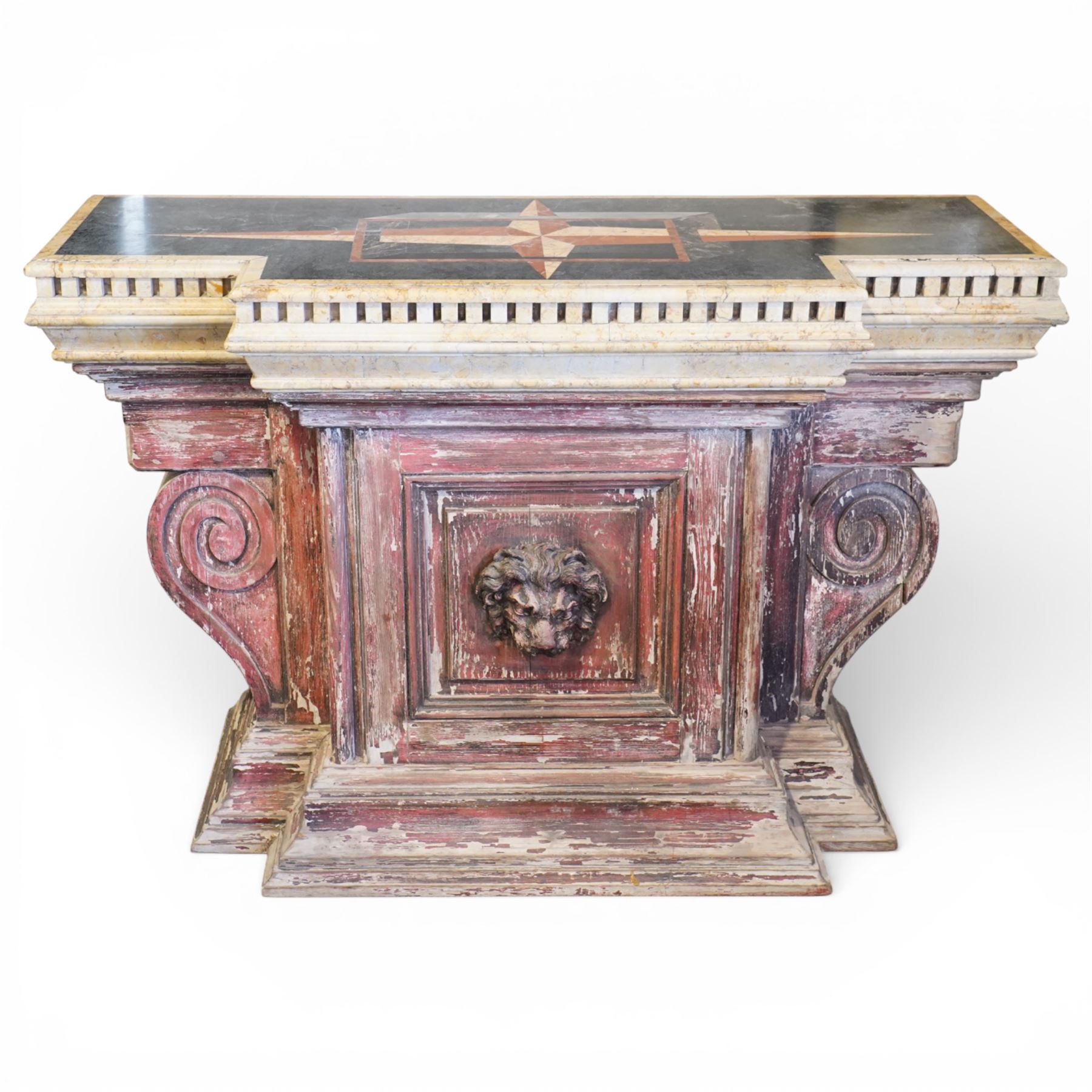 A 20th century Italian Neoclassical console table of monumental architectural form, inspired by Roman altar and sarcophagus prototypes; the rectangular marble top with dentil-moulded edge and polychrome geometric compass-star inlay, executed in contrasting marbles on a dark green ground, above a pedestal base of simulated stone finished in red porphyry-type tones, centred by a lion’s mask in relief and flanked by Ionic scroll volutes, raised on a stepped plinth base