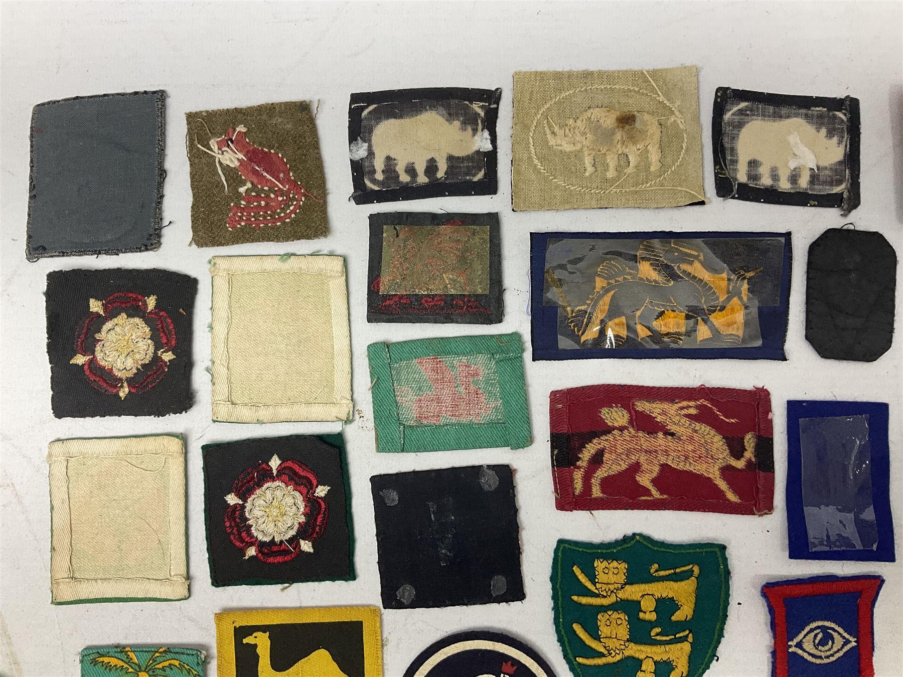 Approximately one-hundred printed and embroidered cloth badges including Royal Tank Regiment, Royal Armoured Corps, 219th Independent Infantry Brigade, Cyrenaica, Cyprus, Singapore and other districts, Gibraltar Garrison, East Anglian Brigade, 20th Armoured Brigade and various armoured divisions etc