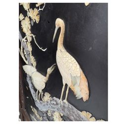 Meiji period (1868–1912), Shibayama lacquer carved hardwood two-fold screen inlaid with mother-of-pearl, bone, and ivory, decorated on one side in high relief and inlaid in a  Shibayama manner with oriental storks flying below flowering branches,  the reverse lacquer panels depicting flowering cherry trees. This item has been registered for sale under section 10 of the APHA Ivory Act.