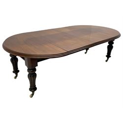 Victorian mahogany extending dining table, circular telescopic extending top with moulded edge, two additional leaves, on turned and lobe carved supports with brass and ceramic castors 