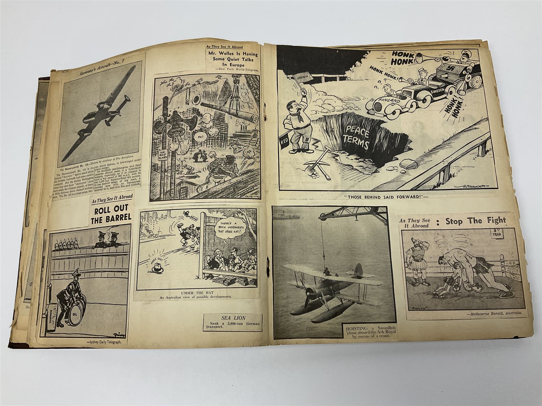 Album of WWII era paper ephemera, to include cartoon illustrations by George Goodwin Butterworth and Clive Uptton, articles and photographs