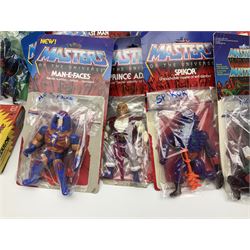 Thirty-one Masters of the Universe He-Man figures re-bagged on original backing cards;  two others lacking backing cards; boxed Modulok figure; bag of weapons and accessories; Roton, two horses and two battle cats; 1986 & 1987 Annuals; Ladybird and other story books; Panini sticker album; instructions etc