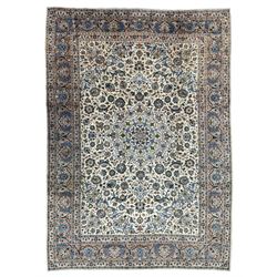 Persian Kashan ivory ground carpet, the interlaced foliate medallion surrounded by trailing plant motifs interlaced with scrolls, the guarded border with repeating stylised flower heads