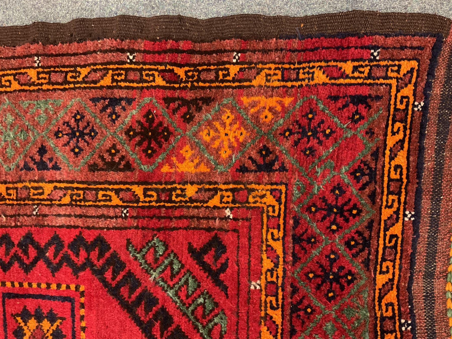 Turkish red ground Rug, repeating border geometric patterned field