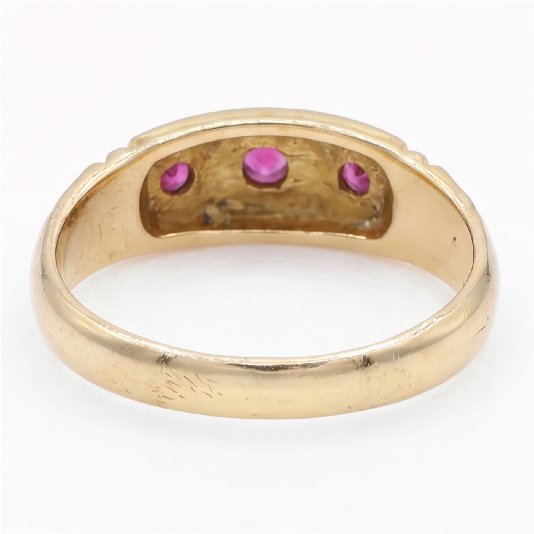 Victorian gold ruby and diamond gypsy ring, three round cut rubies spaced by two star set round cut diamonds, stamped 18ct