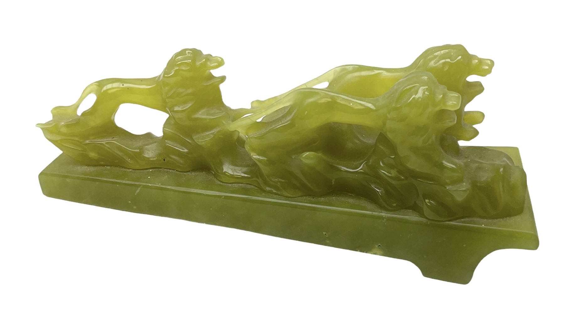 Green stone figural group depicting three lions, upon an inclined base, L21cm