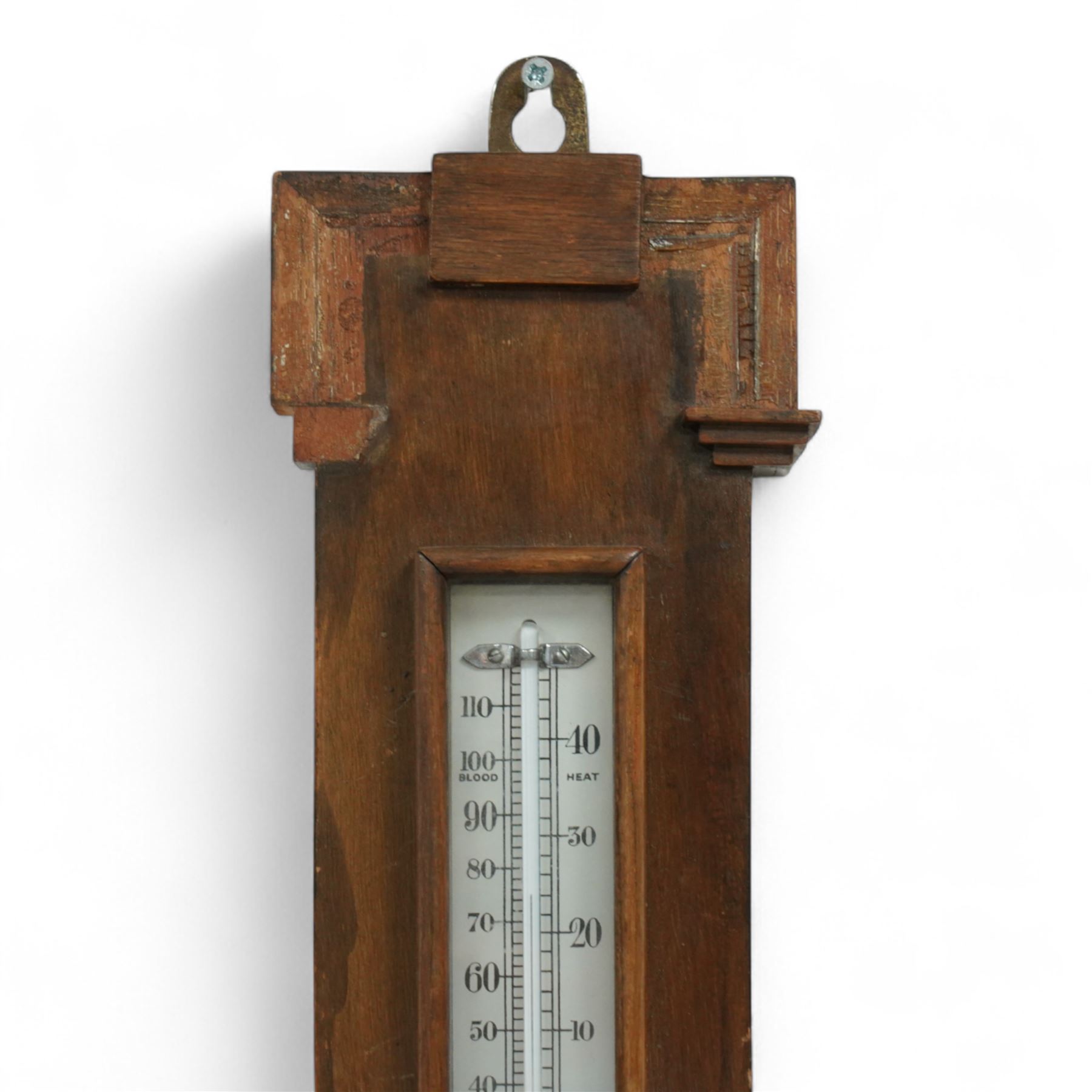 An English 20th century aneroid barometer with a slivered dial and surface mounted mercury thermometer.