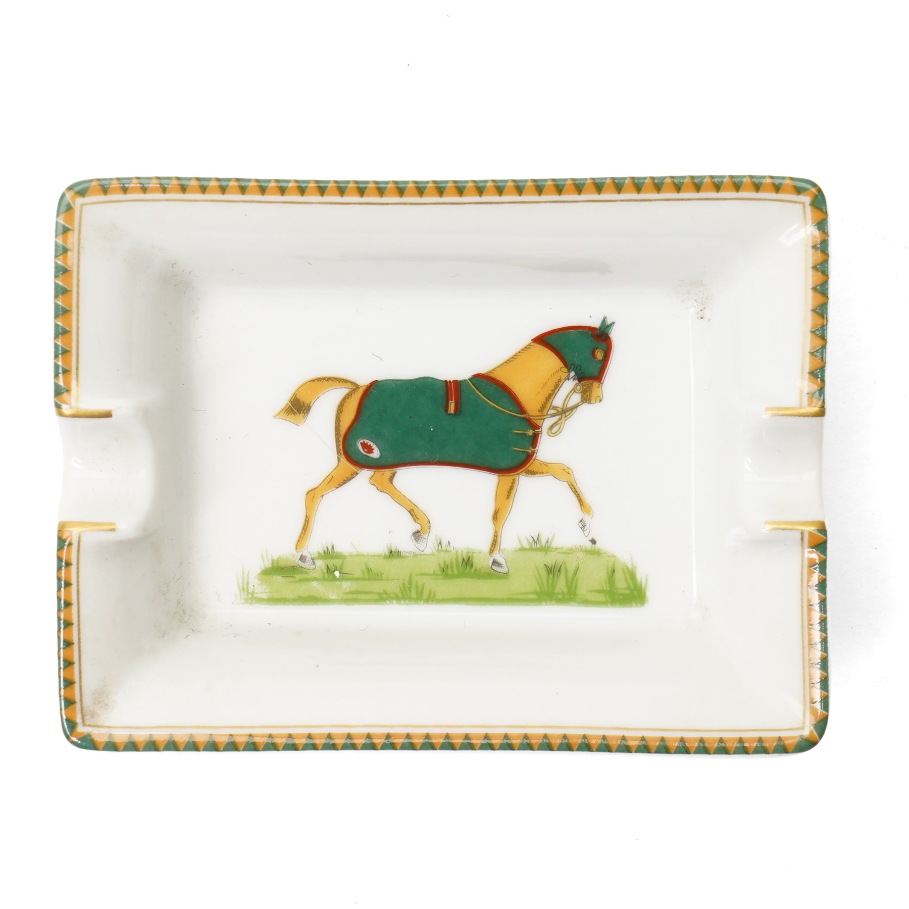 Hermès - set of four miniature porcelain ashtrays, each decorated with a horse in differing blanket, with gilt and coloured borders, in contrasting colour with various horse-coats, in original fitted box