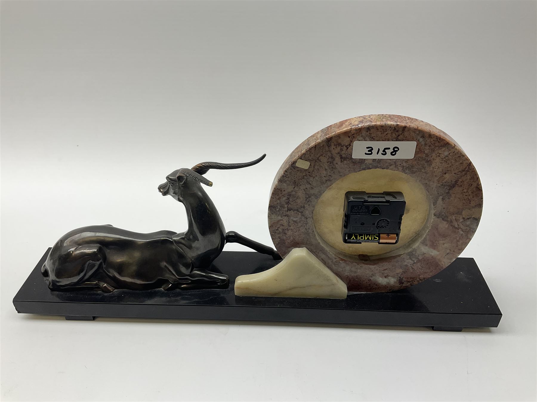 Art Deco style marble and anodised spelter three-piece clock garniture, model with recumbent gazelle, centre piece L52cm.  