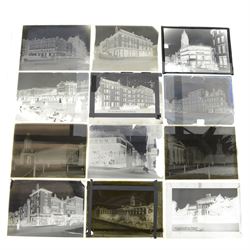 Collection of eleven plate glass negatives, depicting buildings, within a metal case 