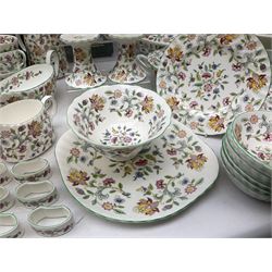 Minton Haddon Hall pattern tea and dinner wares, including basket dish, two covered tureens, six dinner plates, eight dessert plates, twelve tea plates, six soup bowls, six cereal bowls, teapot, coffee pot, milk jug, covered sucrier twelve tea cups and saucers, six mugs, footed bon bon dish, pair of candlestick holders, cake knife and slice etc (81)