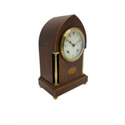 Early 20th century mahogany Lancet shaped mantle clock with an American “Ansonia” eight-day striking movement, case with oval fan inlay and stringing, two recessed brass pilasters, shallow plinth raised on bun feet, movement striking the hours and half hours on a coiled gong, enamel dial with Arabic numerals, minute markers and steel spade hands, within a convex glass and spun bezel. With pendulum 
