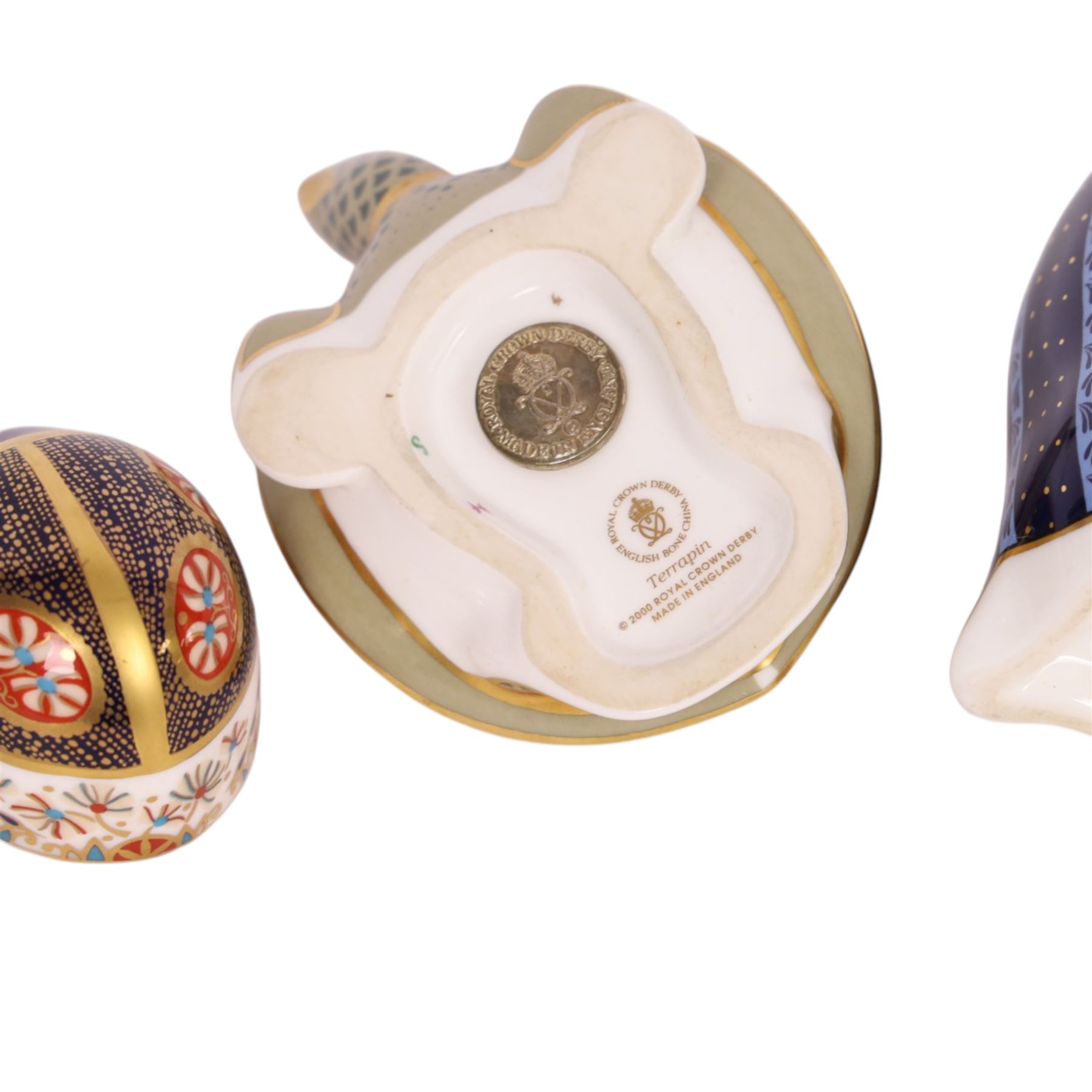 Four Royal Crown Derby paperweights, comprising Terrapin gold stopper, Rockhopper penguin gold stopper, Ladybird gold stopper and Beatle silver stopper