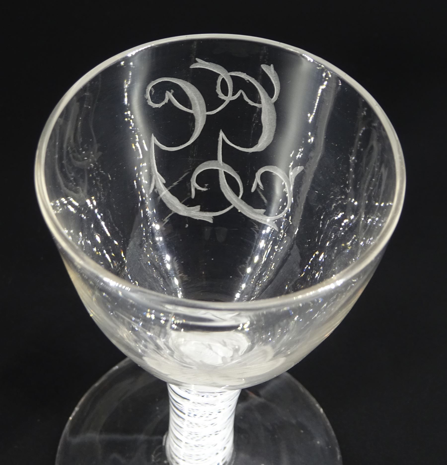 Pair of 18th century drinking glasses of possible Jacobite interest, the ogee bowls engraved with moth and initials 'G.G.', upon a double series opaque twist stems and conical feet, H12cm