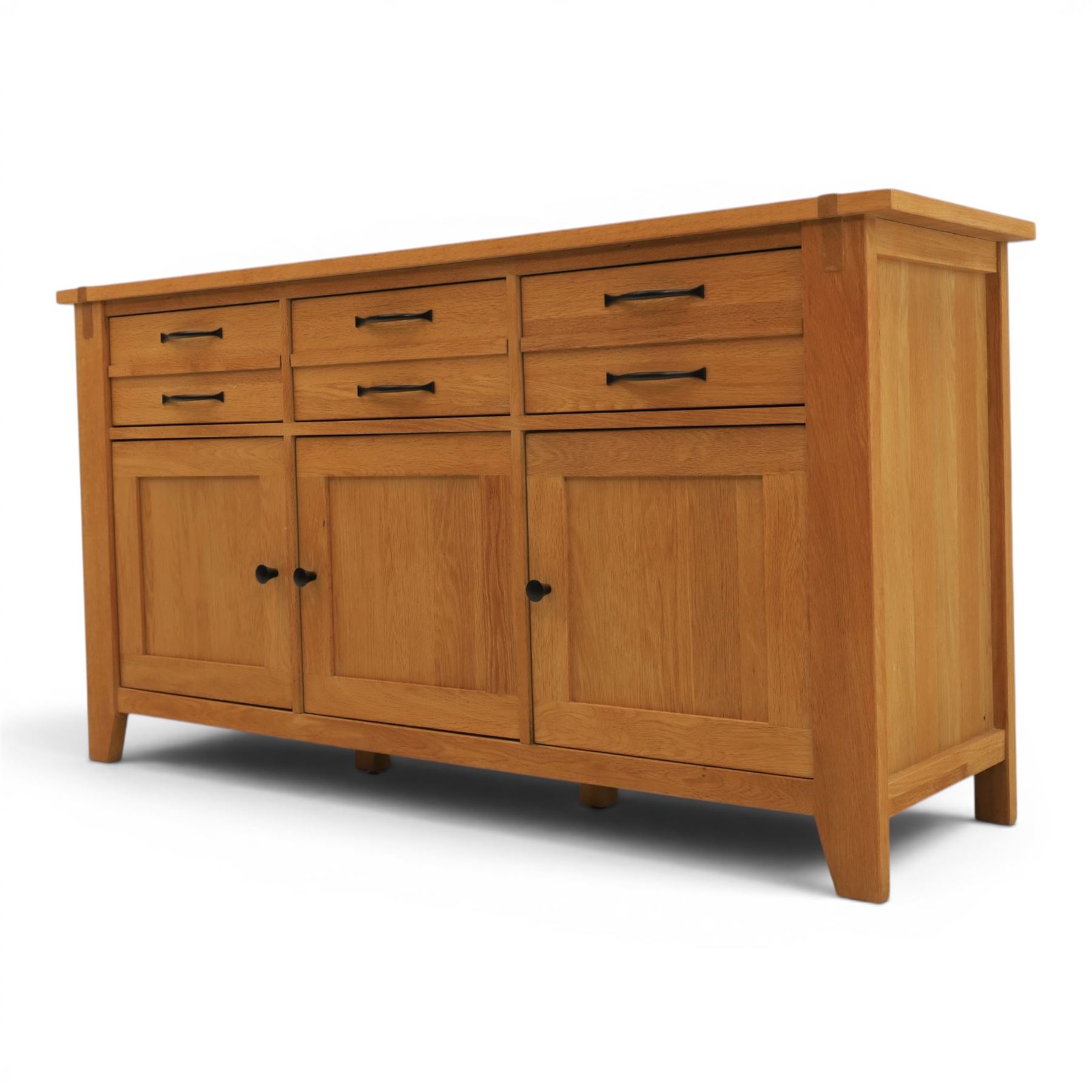Contemporary Oak sideboard, rectangular top with tenon detailing, three drawers over three cupboard doors, blackened metal handles, raised on square supports