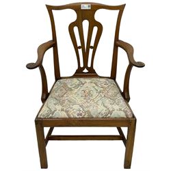 George III walnut elbow chair, shaped cresting rail over shaped pierced splat, the shaped arms with scroll carved terminals, upholstered drop in seat, on square chamfered supports united by plain stretchers 