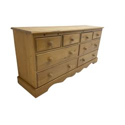 Pine multi-drawer unit, fitted with four short and four long drawers, on shaped plinth base