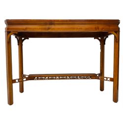 Wade - yew wood console table, rectangular top with canted corners and raised lipped edge, on chamfered square supports united by narrow under-tier