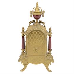 Continental-20th century clock garni in a mid 19th century style case, with porcelain panels and dial, spring driven two train movement with a floating balance escapement, striking the hours and half hours on two bells. With conforming urns. 