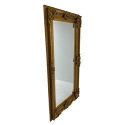 Gilt framed mirror, the frame decorated with shell cartouches and floral scrolls, bevelled plate 181cm x 85cm