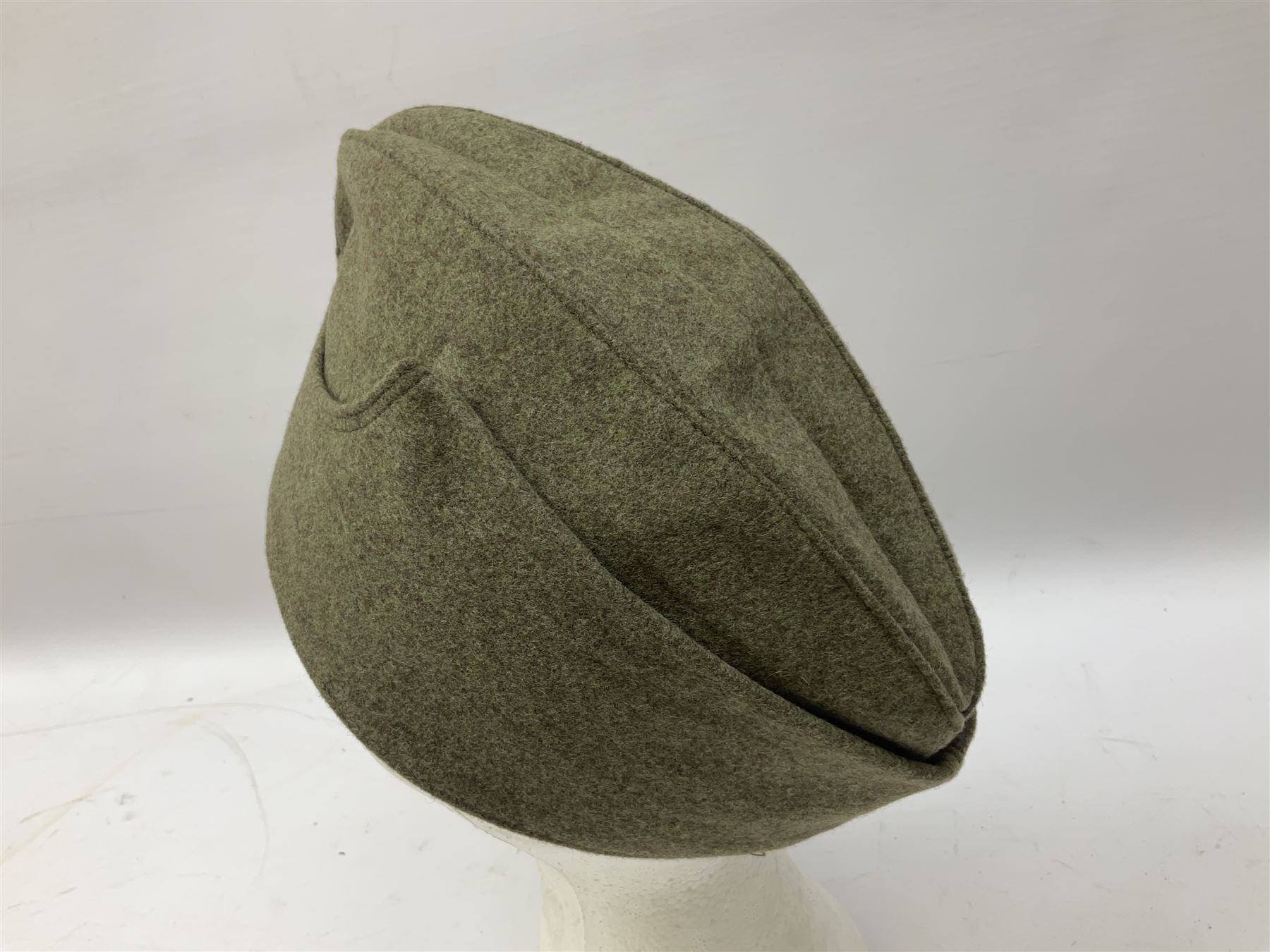 Five reproduction German WW2 hats comprising Wehrmacht olive tropical helmet, Heer officer's peaked cap, two M43 caps and Field side cap (5)