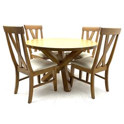 Solid oak circular dining table on angular base and four matching chairs