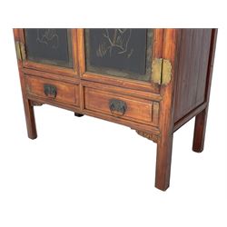Late 19th century Chinese Qing dynasty red and black lacquered wood cabinet,  Fujianese province, upper cupboard enclosed by two doors with relief carved and gilt panels depicting figures behind glass, the large cupboard enclosed by two panelled doors carved with trailing foliate branches and birds, inscribed with Chinese characters, to the left ‘The red mountains are in the shape of Phoenixes and appear auspicious’ and to the right, ‘Wealth and honour are given by flowers and I hear the sound of the phoenix', fitted with two drawers, on square supports with carved brackets 