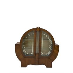 Art Deco walnut display cabinet, of circular design, fitted with two shaped glazed doors enclosing two glass shelves, flanking five glass rods